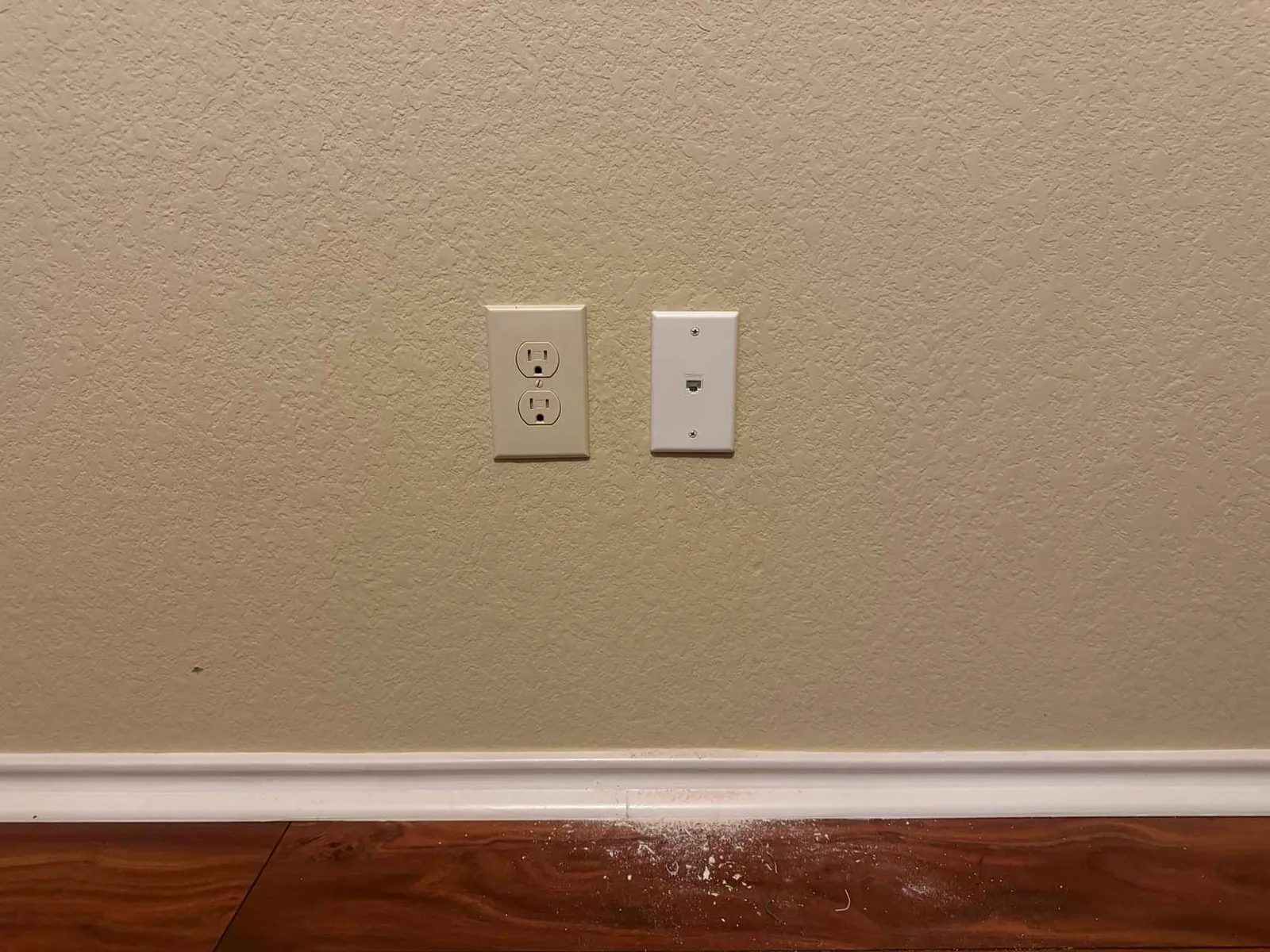 A doorbell is mounted on a white wall.
