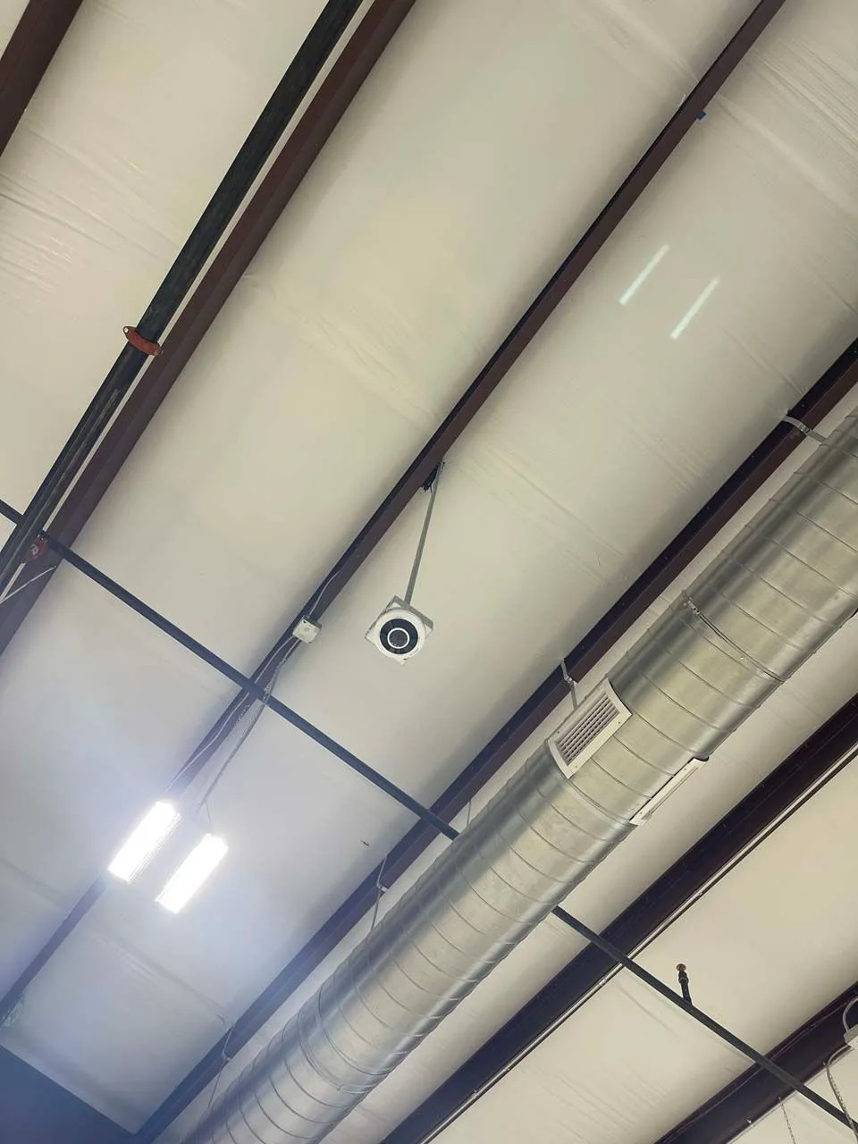 A security camera is mounted on the side of a building.